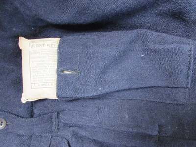 Inserting the First Field Dressing into batltedress pocket