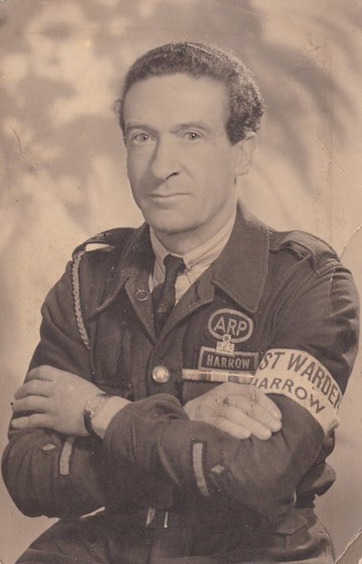 An excellent portrait of George Earl - an ARP Post Warden from Harrow. Wearing the bluette overalls with rank on sleeve, armband, first world war medal ribbon and enamel Royal Life Saving Respiration Badge. (Boddington) 