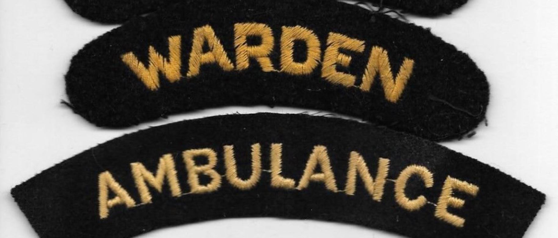 Comparison of the thread colour for a WW2 'old gold' colour (Warden) and post-war Civil Defence Corps 'yellow' (Ambulance) stitching 
