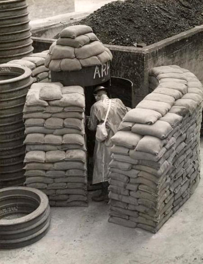 An ARP warden enters his well protected Consol air raid shelter.