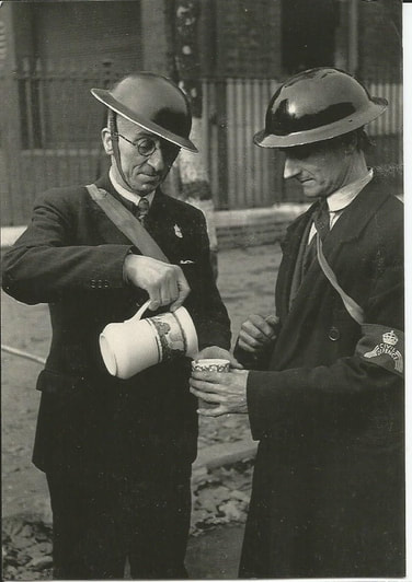 Air raid wardens early in the second world war with unmarked helmets, ARP lapel badge and Civil Defence armband.