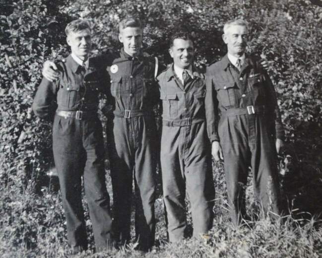 Original wartime photo showing four men wearing the bluette overalls