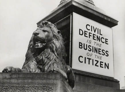 Pre-war Civil Defence is the Business of the Citizen hoarding on Nelson's Column, Trafalgar Square, London