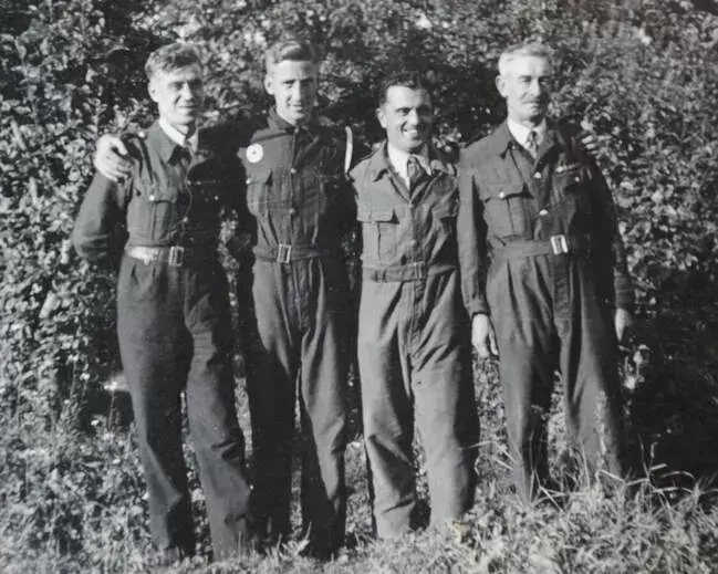 Original wartime photo showing four men wearing the bluette overalls