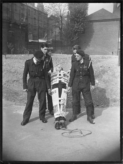 Members of the Civil Defence demonstrate the Neil Robertson stretcher.