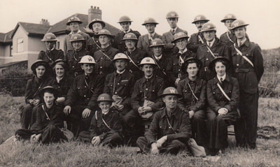 Early war group photo of Wardens in bluette overalls and a very young Messenger.