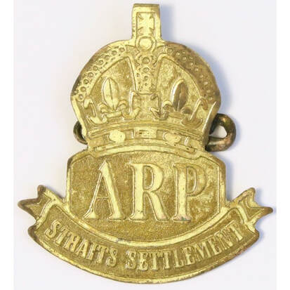 A Straits Settlements ARP brass cap badge.