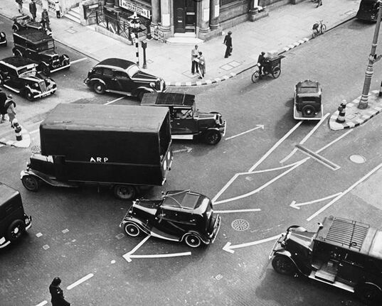 A London road junction showing how the blackout forced the local authority to paint white road markings and also kerbs and street furniture in white.