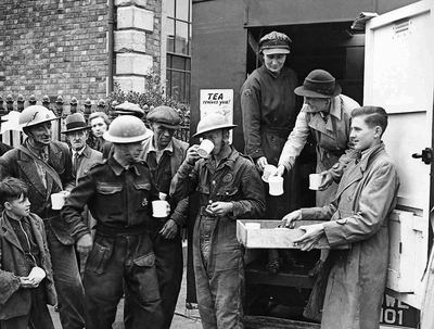 Civil Defence personnel grab a cup of tea following an air raid incident.