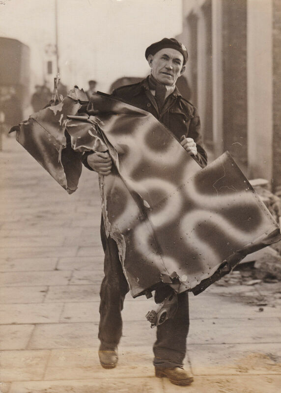 Civil Defence Warden Carries Part of Downed German Aircraft, 1944
